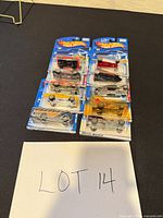 Group shot of eight blister-pack Hot Wheels cars with LOT 14 note
