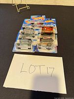 Group of ten sealed Hot Wheels blister cards on table