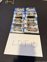 Stacked view of ten carded Hot Wheels cars marked Lot 13