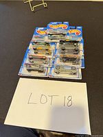 Stack of nine Hot Wheels blister-card cars on table