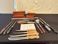 Full lot overview showing knives, honing steels, spoon, sharpening stones, magnetic bar