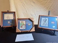 Overview of three framed stamp/art displays with easels and corner protectors