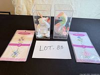 Overview of all items: two Ty Beanie Babies in plastic cases, two sealed Accents handkerchief packs