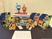 Group shot of all items—three carded Star Wars figures, boxed Haunted Mansion Pop! Town set, two loose Funko Pops, two Baby Groot plushes