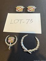 All four Cadillac emblems and ornaments displayed
