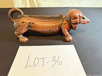 Side profile of cast iron dachshund planter showing overall form and finish