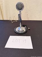 Full front view of microphone on stand with coiled 4-pin DIN cord