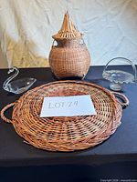 Group shot of all four items: wicker tray, wicker lidded basket, glass swan dish, glass compote