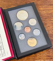 Closed view of display case showing all seven coins