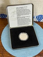 Open RCM case showing coin in capsule and insert card