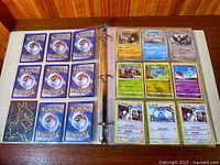 Binder open showing left page of card backs and right page with nine assorted Pokémon card fronts (includes Fennekin, Froakie, Pawniard, Mareep duplicates)