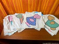 Stack of quilt squares showing Sunbonnet Sue appliqués