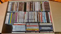 Full box showing three rows of CDs