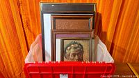 Bin showing multiple framed artworks and frames