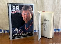 Front covers of both books; signed book opened showing inscription