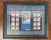 Front view of framed Mantle stamp display showing entire composition
