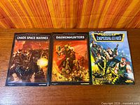 Front covers of all three codex books displayed side-by-side