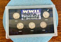 Front view of plastic display showing all five coins and WW II label