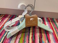 Group view showing wooden and plastic baby hangers with packaging