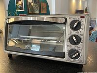 Front view of Black+Decker toaster oven showing controls and handle