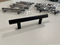 Single black T-bar handle standing upright