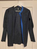 Front view of metallic charcoal cardigan with blue trim