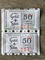 Front of two connected Quebec Gold Star 50 Timbres/Stamps
