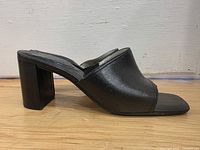 Left side profile of sandal showing leather upper and block heel