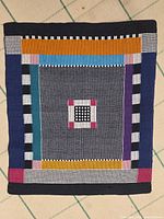 Full view of rectangular tablecloth showing complete geometric design and colours