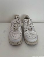 Front view of both sneakers showing toe boxes, laces, overall wear