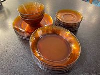 Stacked amber glass bowls and plates on countertop