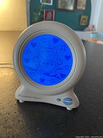 Groclock powered on, blue sleep mode with owl graphic
