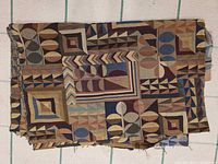 Folded earth-tone fabric showing weave and pattern