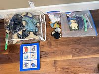 Overview of all items: Inuit plush in bag, Beanie Babies in bag, booklet