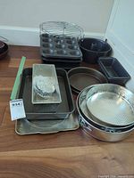 Group view of entire bakeware lot stacked on floor