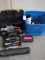 Overview of toolbox, tote, trays of hand tools, level and Porter-Cable case