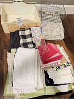 Full lot overview showing crate, basket and stacked linens