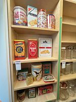 Shelf view showing majority of tins on three levels