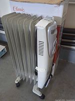 Side view of heater showing seven fins, caster wheels and box