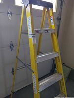 Full view of yellow Davidson fiberglass step ladder opened