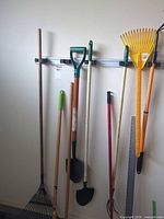 Full view of tools hanging on wall rack