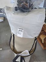 Rolled air bed in carry bag with pump parts visible