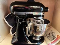 Black KitchenAid Ultra Power mixer with stainless bowl and attachments visible