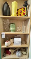 Shelf with multiple vases, figurines and decor pieces