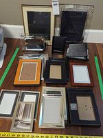 Group shot of all picture frames and holders arranged to show quantity, sizes and colors