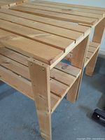 Two-tier pine shelving showing slatted surfaces and legs