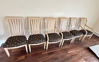Six wood dining chairs lined up