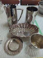 Group shot of all five silver-plated pieces on table