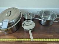 All cookware pieces arranged together showing size relative to tape measure