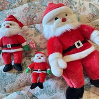 All three Ty Santa plush toys side by side for size comparison